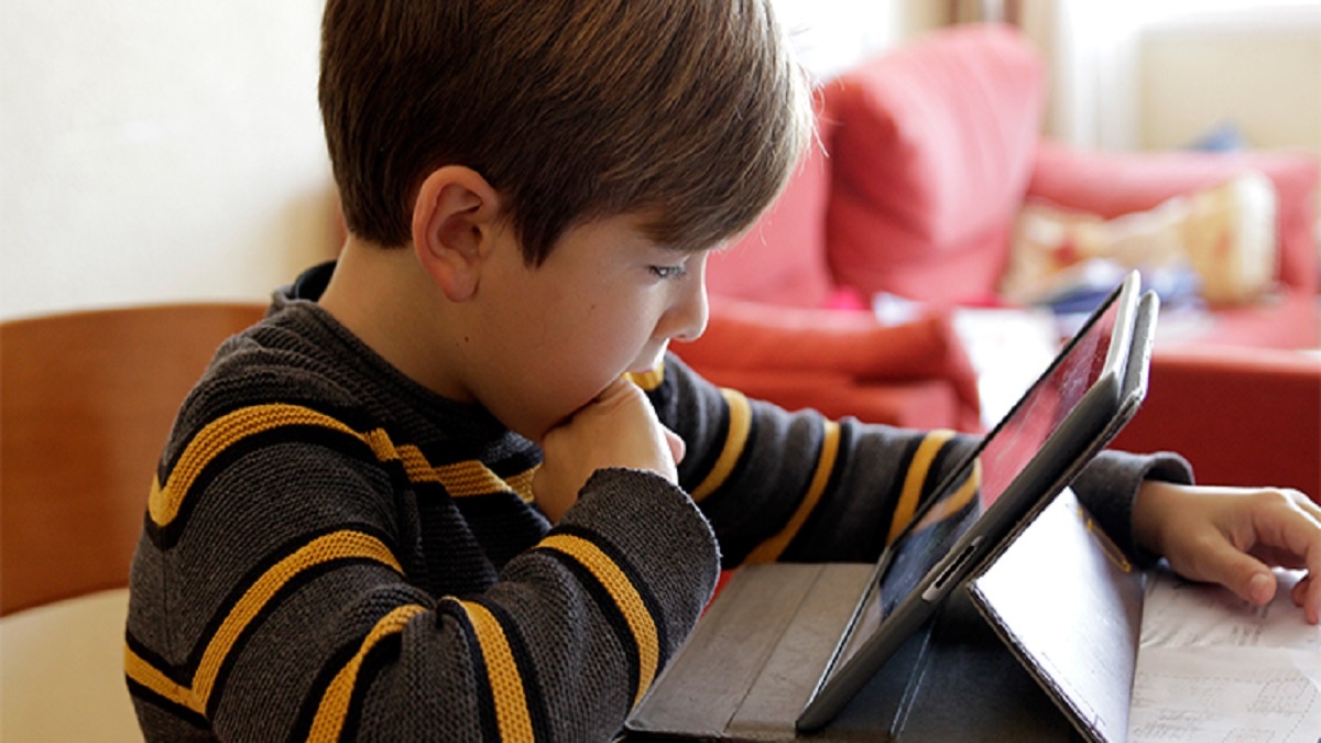 imagen de un niño mirando atentamente su tableta.